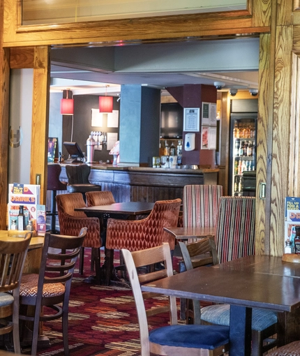 Interior dining area of a pub with a bar.