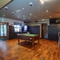 Interior dining area of a pub with a pool table, a gambling machine and a TV.