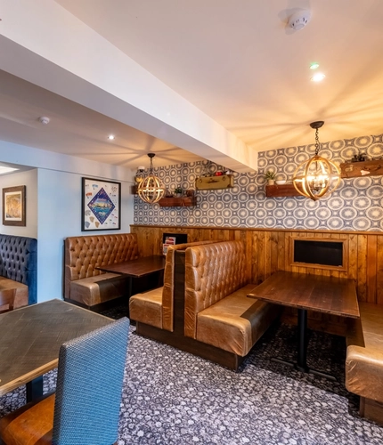 Interior dining area of a pub with TVs.