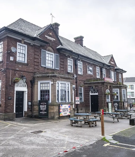 Exterior facade of a pub with a seating area.