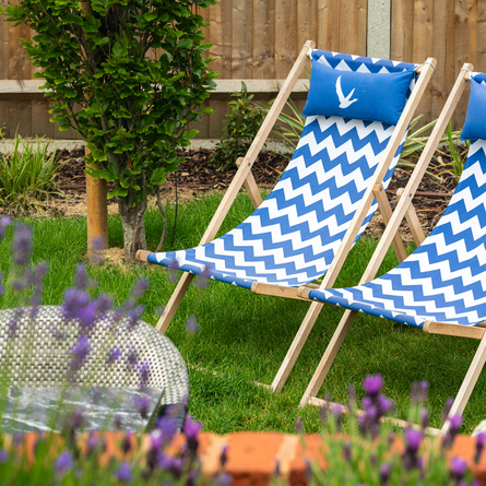 Exterior beer garden seating area with two deckchairs at the rear of the Prince Of Wales.