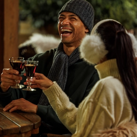 An image of 2 people enjoying festive drinks within the exterior beer garden seating area at The Watermill.