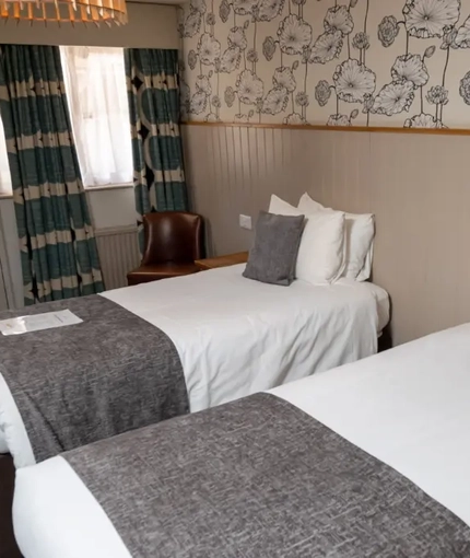 The interior hotel twin bedroom with two single beds at the Cedars Inn.