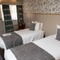 The interior hotel twin bedroom with two single beds at the Cedars Inn.