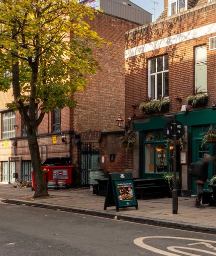 The exterior facade with outdoor seating benches at The Lucas Arms.