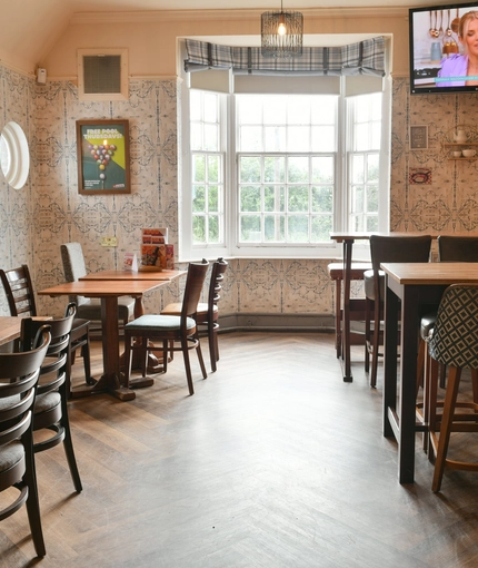 Interior dining area of a pub with a TV.