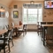 Interior dining area of a pub with a TV.