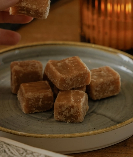 A lifestyle image of a plated fudge dish from the Burns Night menu sat on a table within the interior restaurant seating area at The Crown.