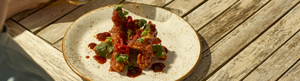 An image showing the sticky barbeque chicken dish served on a plate at Chef & Brewer.