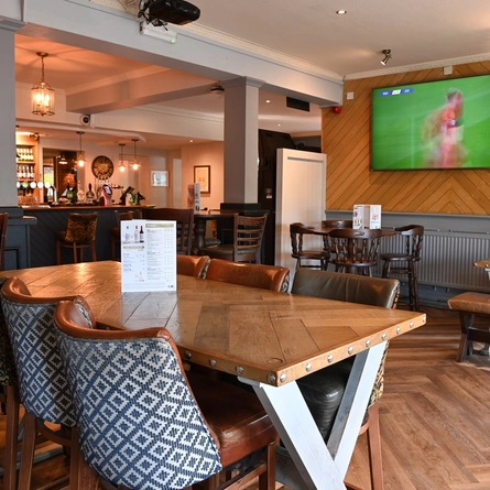 Interior dining area of a pub with a bar.