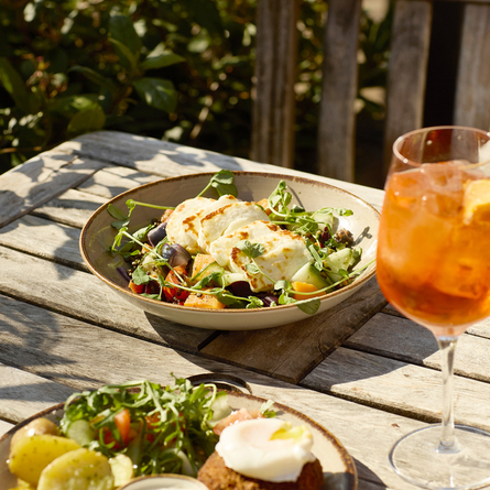 An image of a dish from the new menu within the exterior seating area.