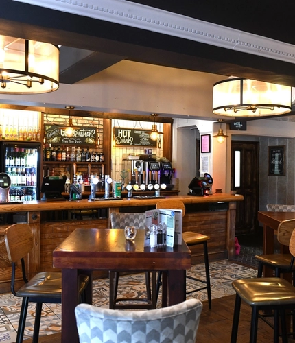 Interior dining area of a pub with a bar.