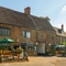 The beer garden with picnic benches and parasols at The Red Lion, Adderbury.