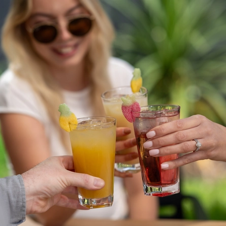 Some cocktails being cheersed.