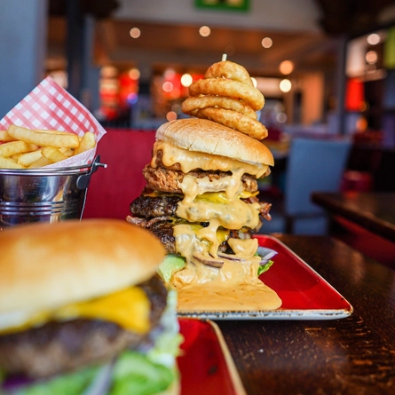A plate of cheeseburger stack on a table