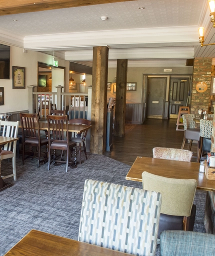 Interior dining area of a pub with a TV.
