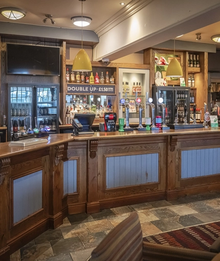 Interior bar area of a pub with a seating area.