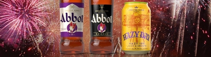 An advertising image of a can of Hazy Day, a bottle of Abbot Ale and a bottle of Abbot Reserve with a fireworks background.