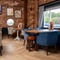 The interior restaurant seating area of The Stanley Ferry, with wooden tables, upholstered seats, and a TV on the wall. 