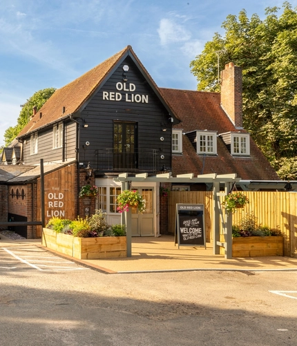 The exterior facade and car park at The Old Red Lion.