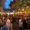 An evening image of crowds stood within the beer garden area during The Boat Race event at The Crabtree.