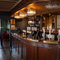 An image of the interior bar with wooden front panelling, ceiling beams and wooden flooring at The Spice Island.