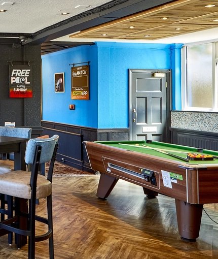 The interior restaurant seating area with TVs and pub games, at The Good Intent in Hornchurch.