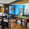 The interior restaurant seating area with TVs and pub games, at The Good Intent in Hornchurch.
