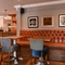 Interior seating area of a pub with a bar.