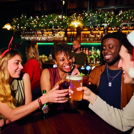 An image of people enjoying drinks within the interior of a Greene King Pub venue.