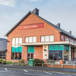 Exterior facade of a pub with a seating area.