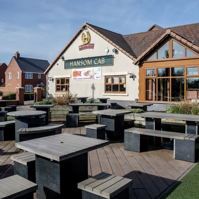 Exterior beer garden of a pub with a seating area.