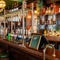 The dark wood panelled bar inside the King's Head in Bayswater, with bar stool seating; dark wood flooring with a checkerboard tile pattern by the bar; and glasses hanging in racks above the counter.