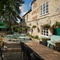 The exterior beer garden with benches, umbrellas and tables with chairs at the Apple Tree.