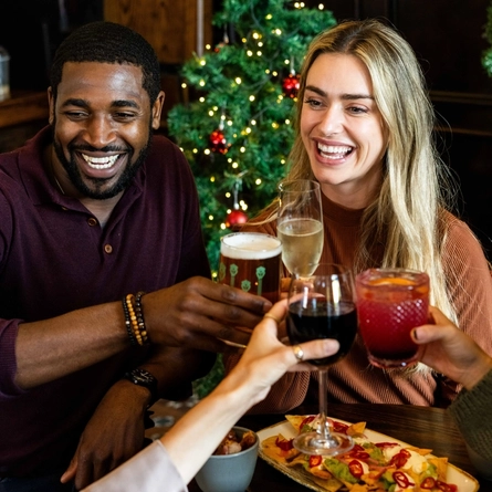 Two people enjoying festive drinks in the pub