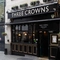The exterior facade and venue signage of The Three Crowns.
