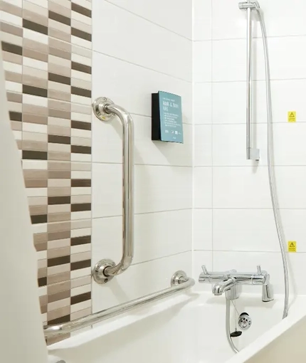 The interior of an accessible hotel room bathroom at The Quays.