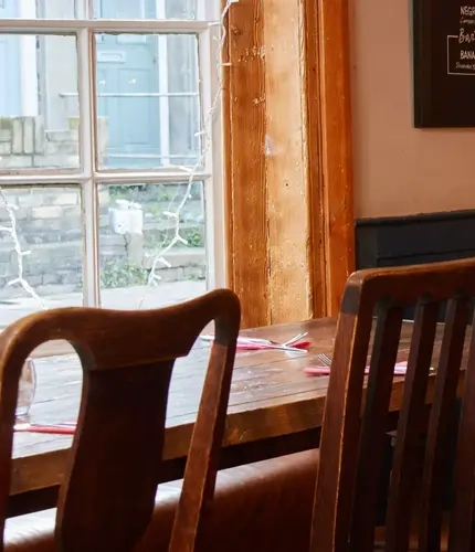 Interior restaurant tables with benches and chairs  