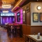 The interior bar and restaurant seating area with live event stage in the background at The City Of Quebec.
