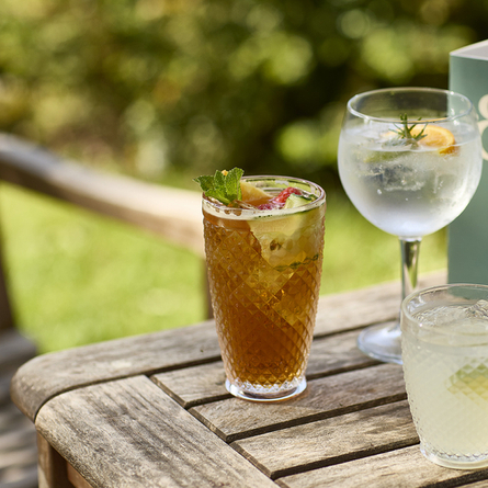 An exterior shot of summer drinks being served for the Summer Drinks Promo at Chef & Brewer venues.
