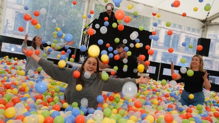 a group of people having fun in a ball pit