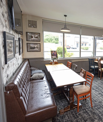 Interior dining area of a pub with a TV.