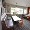 Interior dining area of a pub with a TV.