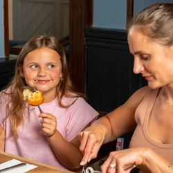 An image of a family enjoying a Sunday Roast and various drinks within the interior restaurant and seating area at a Hungry Horse venue.