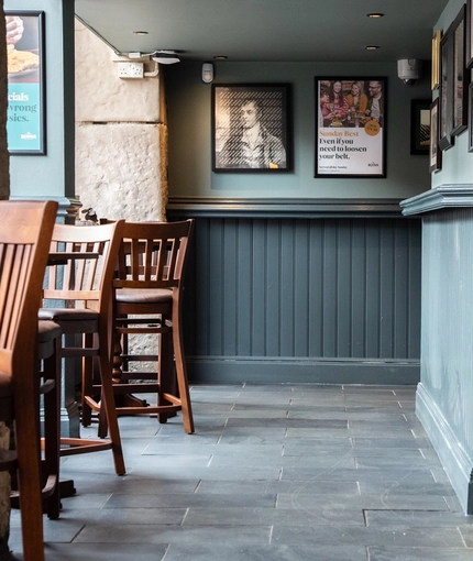 The interior seating area and wood panelled walls at Coopers in Glasgow.