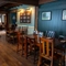 An interior restaurant seating area at The Rising Sun in Wistaston, with wood panelled walls, wooden beams on the walls and ceiling, and a brick fireplace.