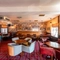 Interior dining area of a pub with a TV and a few gambling machines.