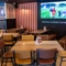 An interior restaurant seating area at The Lodge in Alvaston, with upholstered bench seats, dartboards, and a large TV on the wall.