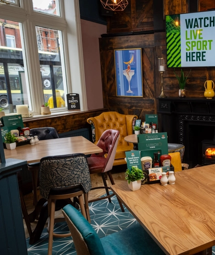 The interior restaurant and seating area with TV and fireplace at the Ship and Royal.