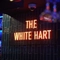 A neon sign on the wall of the White Hart.